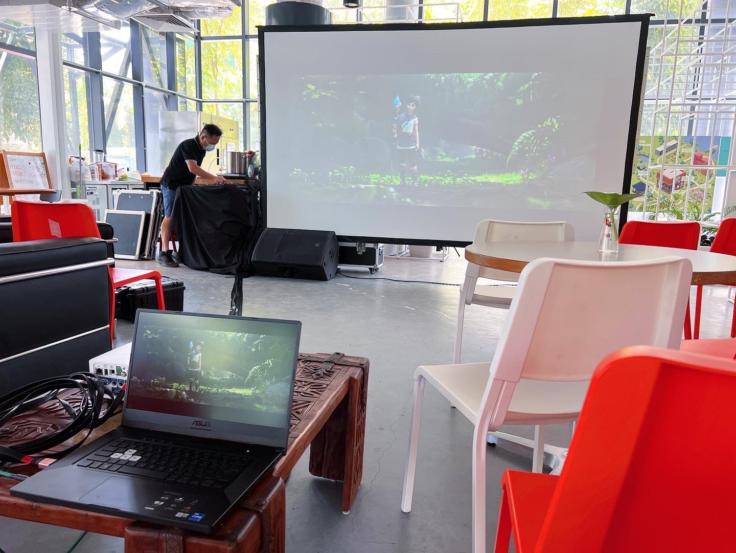 Movie Screening: 6 Easy Ways to Plan Better Seating 4 Chairs and a playback laptop facing a portable screen in a lounge