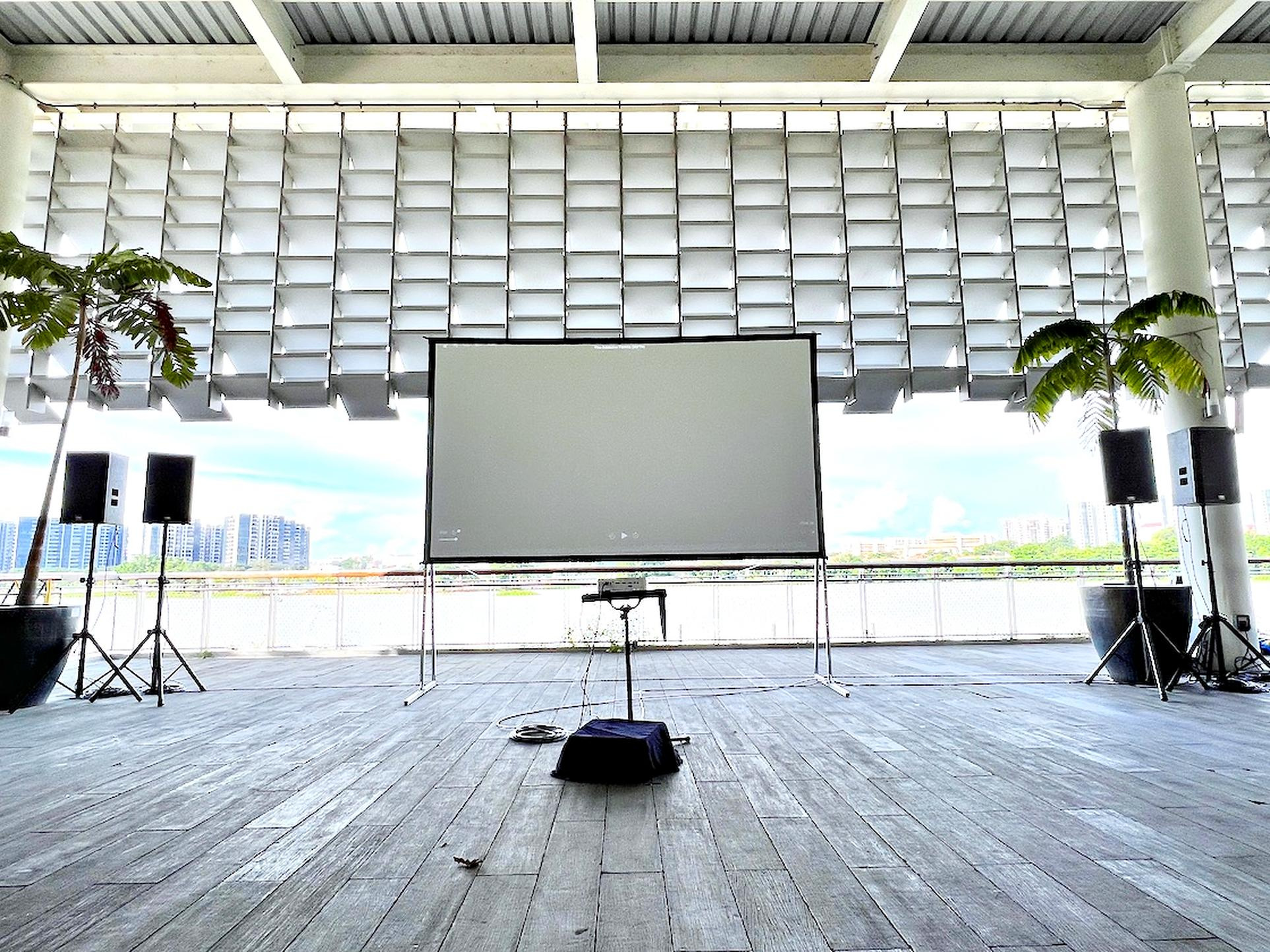 Movie Screening: 6 Easy Ways to Plan Better Seating 5 Projection screen between two speakers in a covered waterfront venue